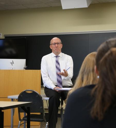 Faculty member lecturing to students in a Holy Family classroom